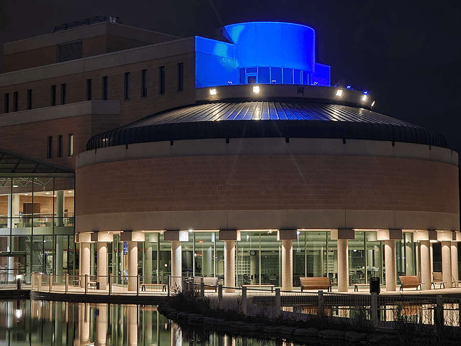 Markham City Hall roof illuminated blue for Light It Up! For NDEAM.