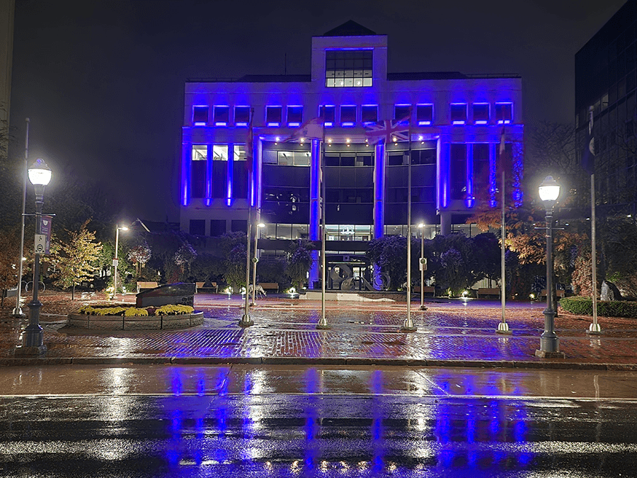 Markham City Hall roof illuminated blue for Light It Up! For NDEAM.
